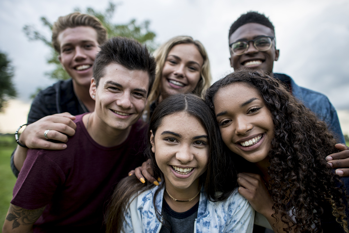 A group of teens looking at the camera and smiling