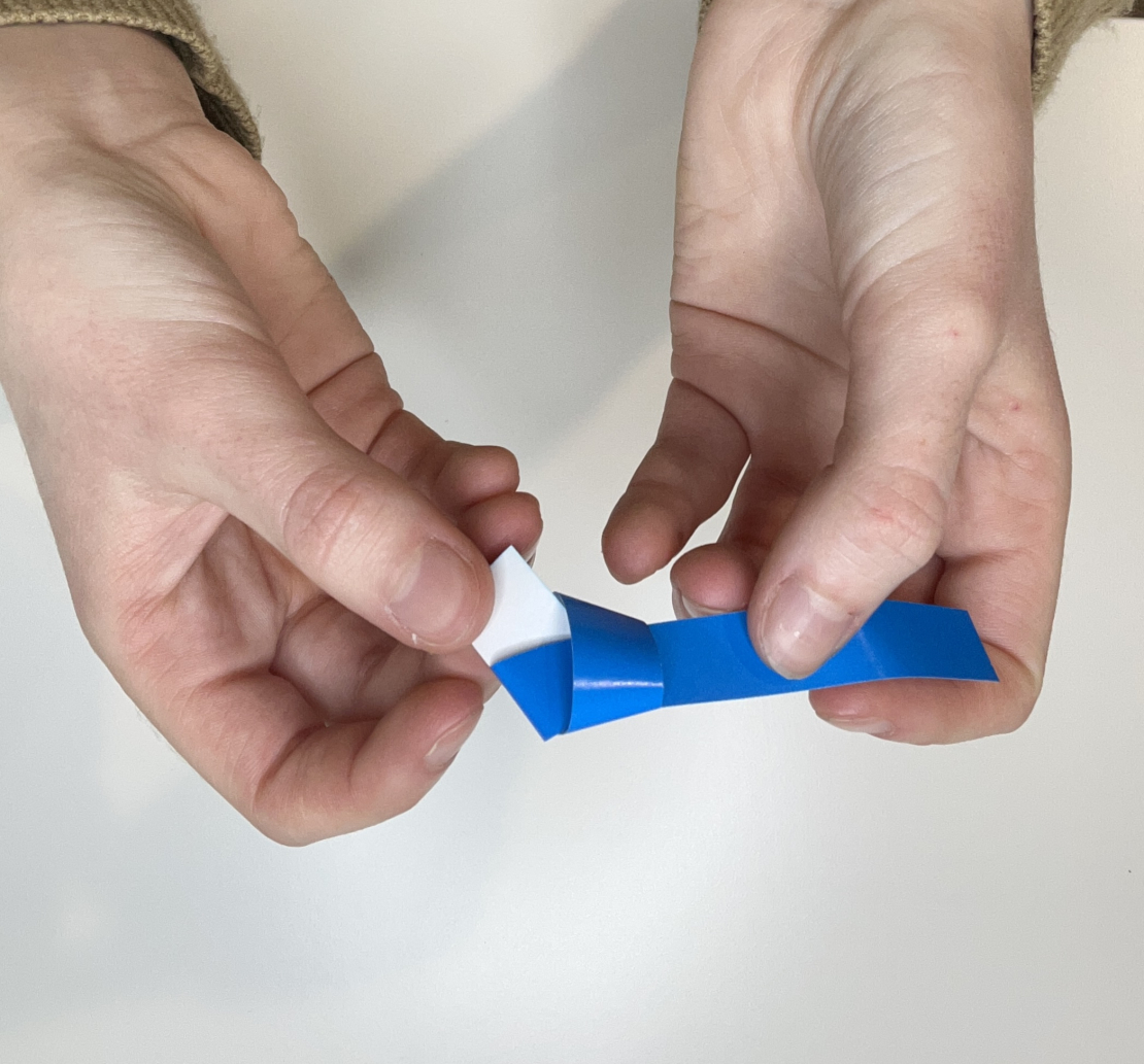 Blue paper strip making a knot. 