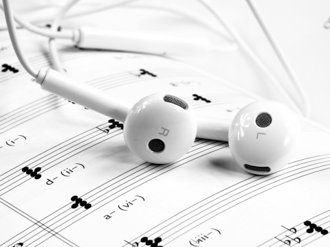 Earbuds on a sheet of music