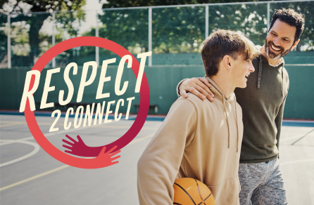 Two males on a court and one is holding a basketball. The Respect2Connect logo is to the left of the males.