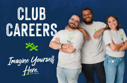 A group of three happy employees standing together and smiling.