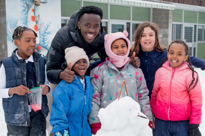A group of happy youth with a youth leader.